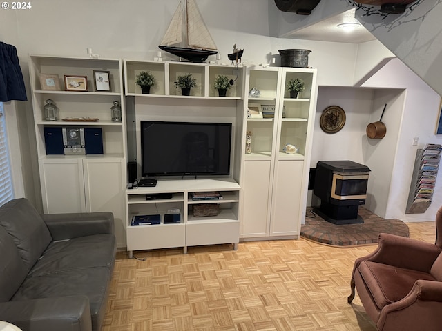 living room with light parquet floors and a wood stove