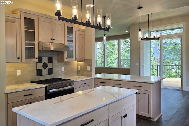 3404 River Heights Dr, Springfield, OR 97477 - kitchen featuring gas range oven, a center island, under cabinet range hood, and plenty of natural light