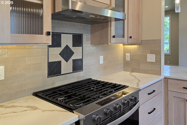 3404 River Heights Dr, Springfield, OR 97477 - kitchen with stainless steel range with gas stovetop, exhaust hood, decorative backsplash, and light stone counters