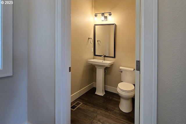3404 River Heights Dr, Springfield, OR 97477 - half bath with wood finished floors, toilet, baseboards, and a sink
