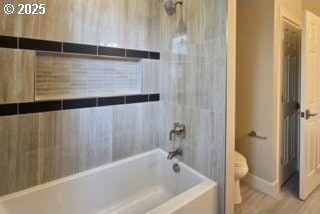 3404 River Heights Dr, Springfield, OR 97477 - full bathroom featuring toilet, bathtub / shower combination, wood finished floors, and baseboards