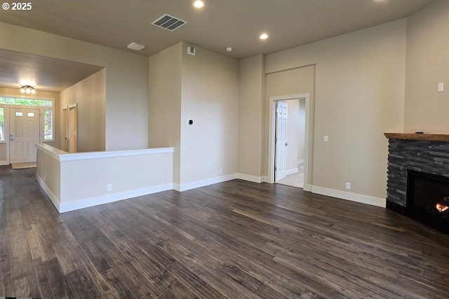 3404 River Heights Dr, Springfield, OR 97477 - unfurnished living room with dark wood-style floors, a stone fireplace, recessed lighting, and baseboards