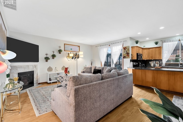 living room with light hardwood / wood-style flooring