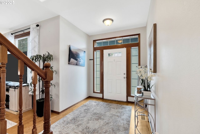 foyer entrance with light hardwood / wood-style floors