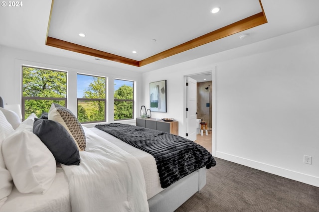 bedroom with a raised ceiling and carpet floors