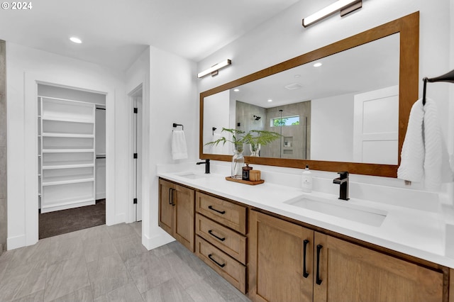 bathroom with a shower with door and vanity