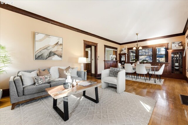 living room featuring light hardwood / wood-style flooring and ornamental molding