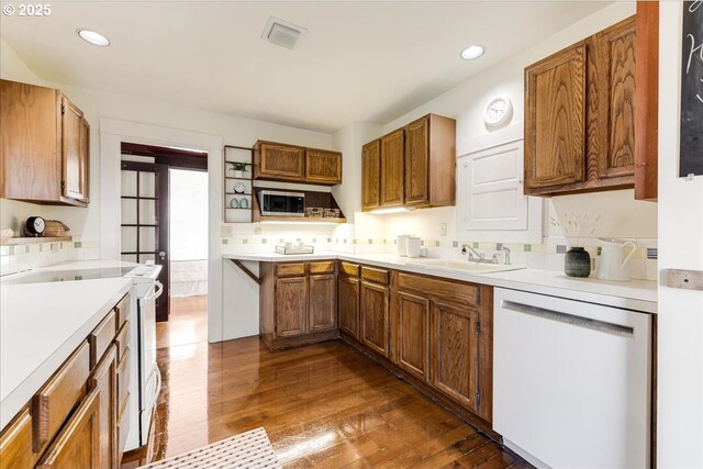 kitchen featuring sink, white appliances, and hardwood / wood-style floors