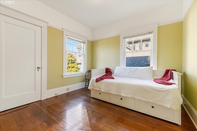 bedroom with dark wood-type flooring