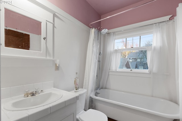 full bathroom with vanity, shower / bath combination with curtain, and toilet