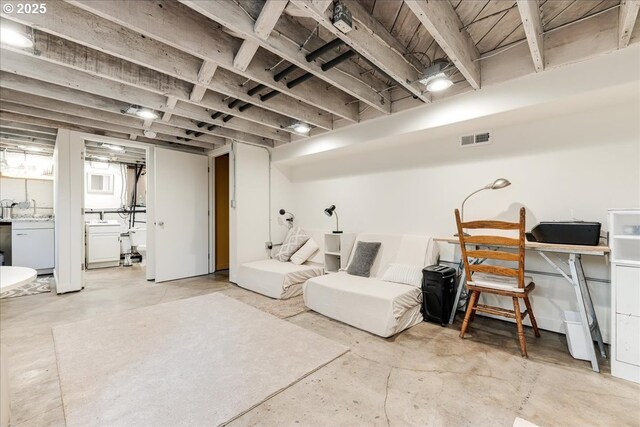 basement featuring sink and washer / clothes dryer