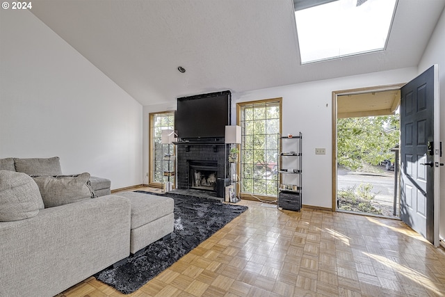 living room with vaulted ceiling, a brick fireplace, and parquet floors