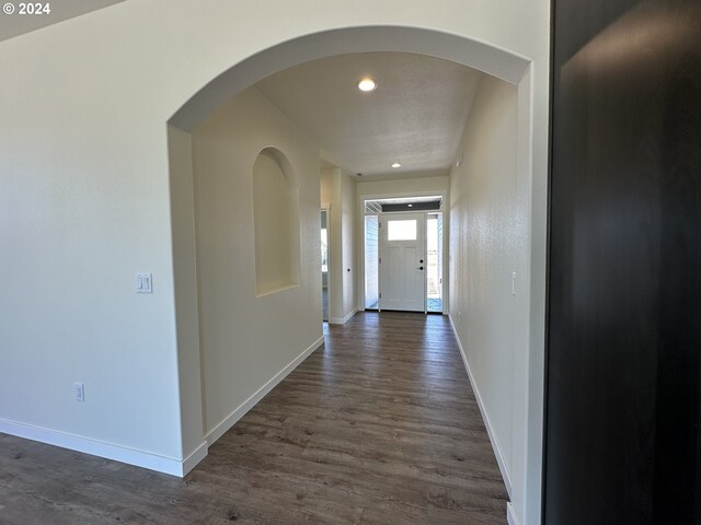 hall with dark hardwood / wood-style flooring