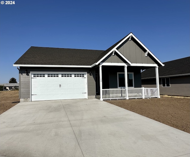 view of front of home featuring a porch and a garage