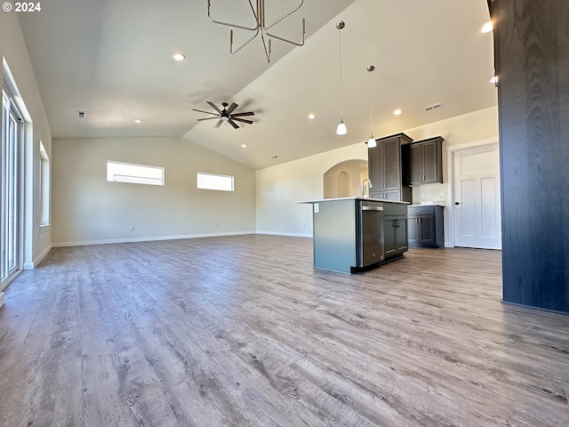 unfurnished living room with vaulted ceiling, ceiling fan, and light hardwood / wood-style flooring