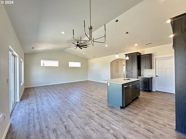 kitchen featuring sink, ceiling fan, hanging light fixtures, an island with sink, and stainless steel dishwasher