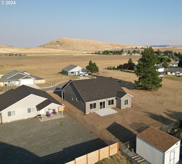 drone / aerial view featuring a mountain view and a rural view