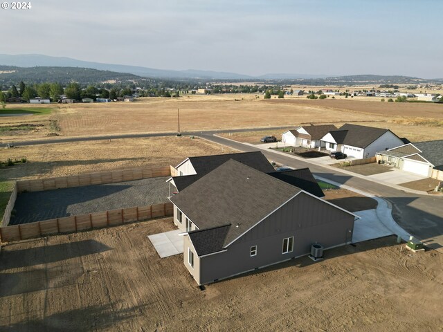 drone / aerial view featuring a mountain view and a rural view