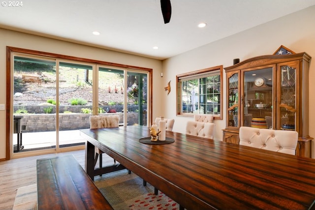 dining space with recessed lighting and light wood-style flooring