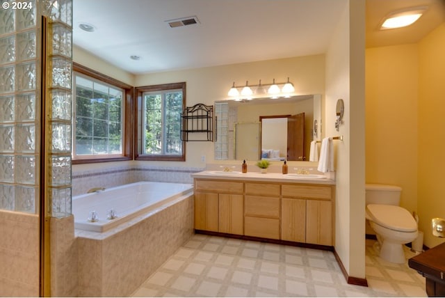 full bathroom with visible vents, a garden tub, double vanity, tile patterned floors, and a sink