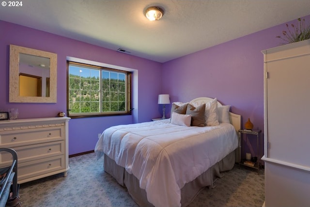 bedroom with light colored carpet, visible vents, and baseboards