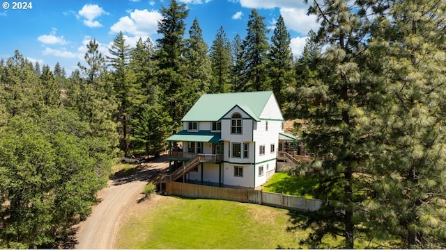 birds eye view of property featuring a view of trees