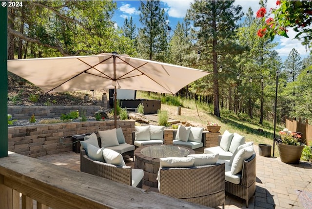 view of patio with an outdoor living space and a hot tub