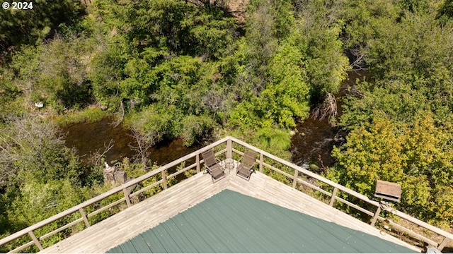 wooden deck featuring a wooded view