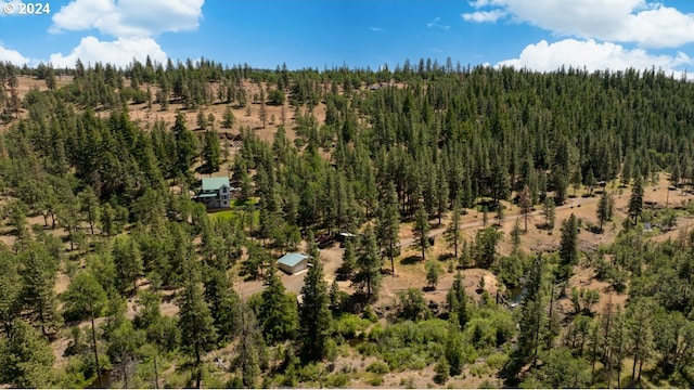 birds eye view of property with a wooded view