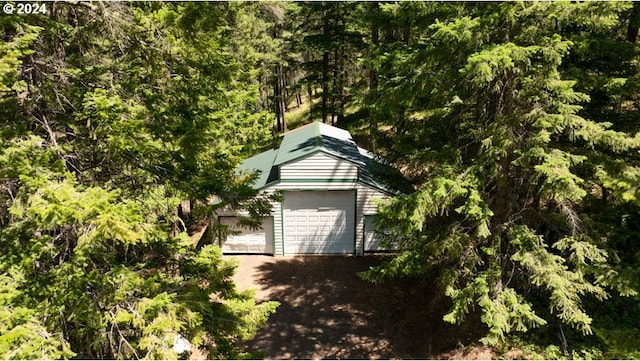 garage featuring a forest view