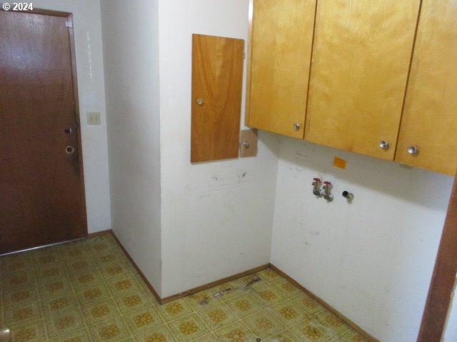 washroom with cabinets and tile patterned floors