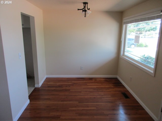 unfurnished room featuring dark hardwood / wood-style flooring