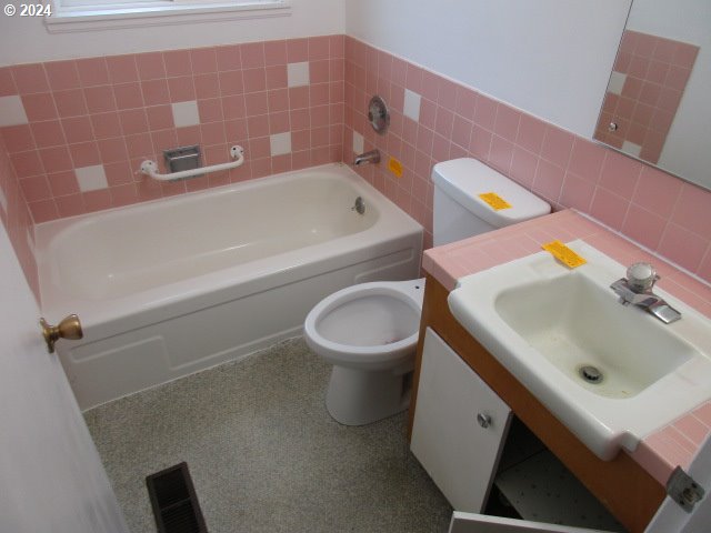 bathroom featuring toilet and vanity