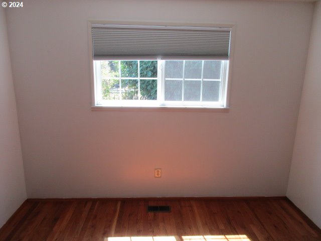 spare room featuring hardwood / wood-style flooring