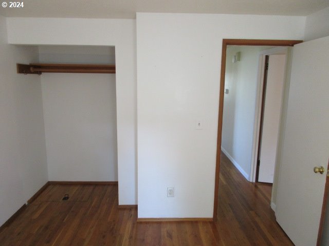 unfurnished bedroom featuring dark hardwood / wood-style floors