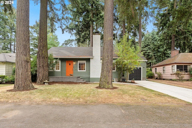 view of front of house with a front yard and a garage