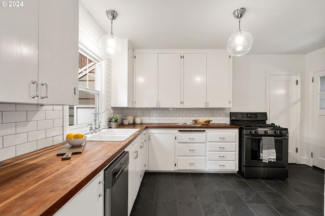 kitchen featuring black range with gas stovetop, hanging light fixtures, butcher block counters, and sink