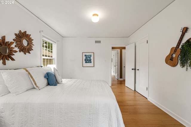 bedroom with light hardwood / wood-style floors