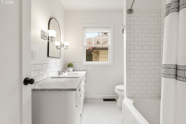 full bathroom with tile patterned flooring, vanity, toilet, and shower / bath combo with shower curtain