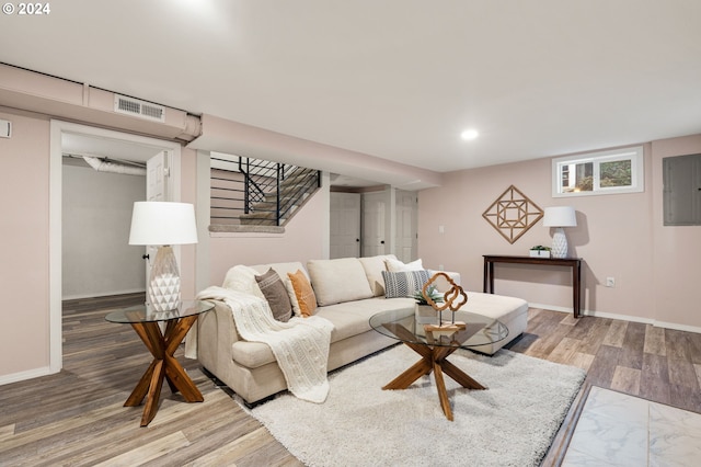 living room featuring wood-type flooring and electric panel