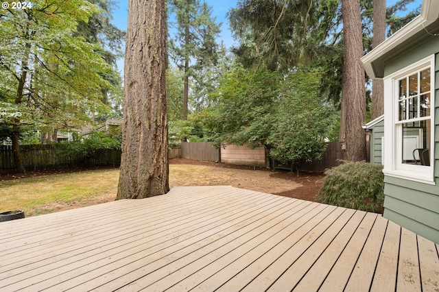 wooden terrace featuring a yard