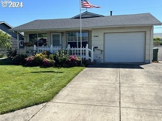 single story home with a porch, a garage, and a front lawn