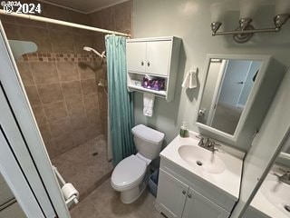 bathroom with tile patterned floors, toilet, vanity, and a shower with shower curtain