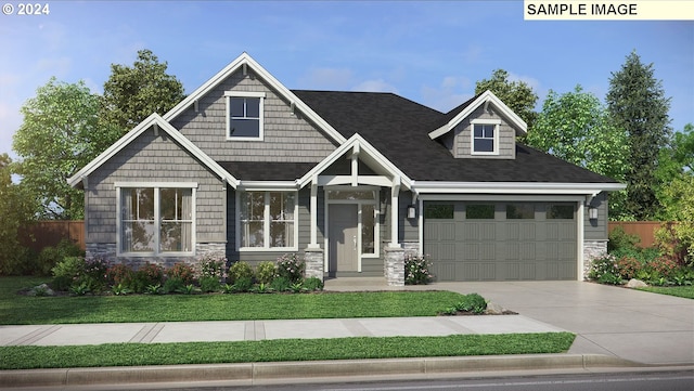 craftsman-style home featuring a garage and a front lawn