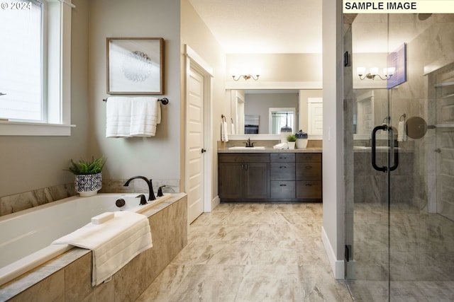 bathroom featuring vanity and independent shower and bath