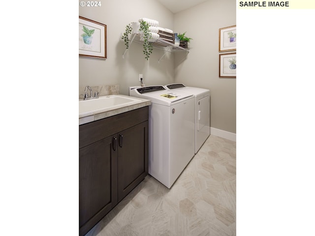 laundry area with cabinets, separate washer and dryer, and sink