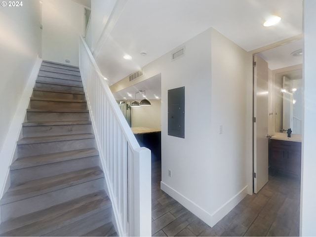 staircase with dark wood-type flooring