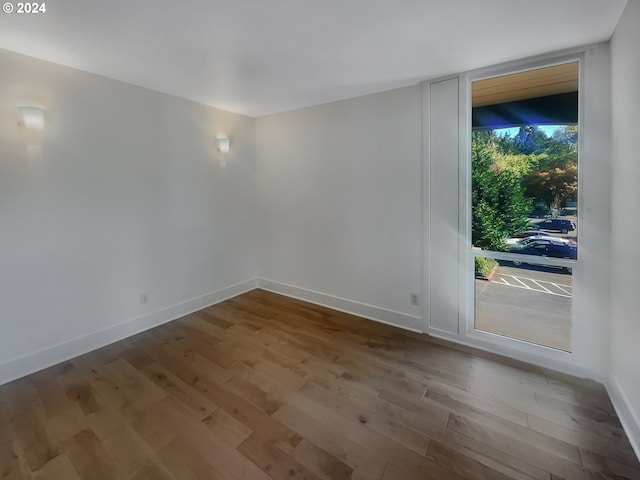 empty room with hardwood / wood-style floors