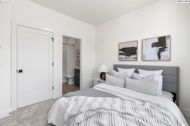 carpeted bedroom featuring connected bathroom