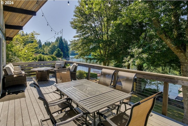 wooden terrace featuring a water view